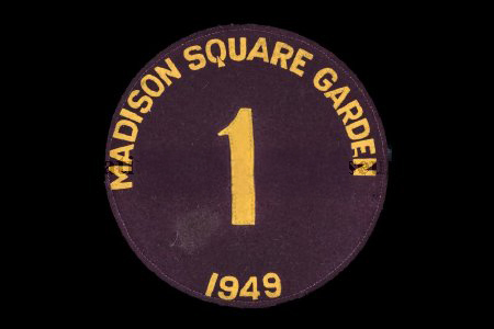 A dark circular patch with gold text reading MADISON SQUARE GARDEN around the top, the number 1 in the center, and 1949 at the bottom, all on a black background.