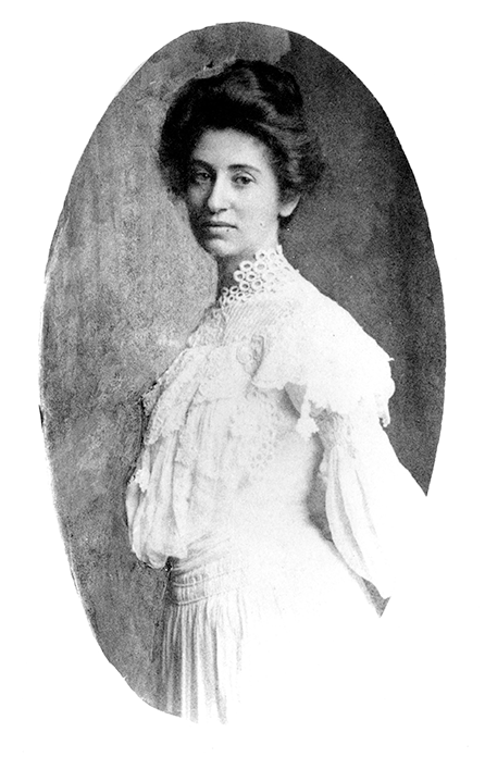 Portrait of a woman in a vintage white lace blouse with a high collar, posed in an oval frame.
